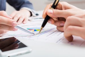 Business men and woman reviewing Quickbooks