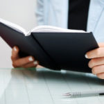 business woman reading a small business book