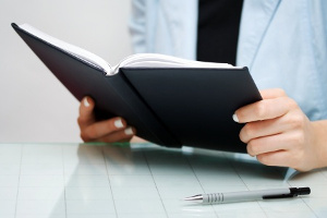 business woman reading a small business book