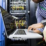 Network Depot EOL IT Man Working On Laptop In War room