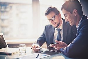 two business men who work at a small business and are discussing how their company will be able to get through the hurricane season
