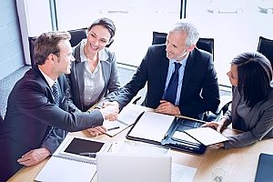 a business meeting among members of a nonprofit organization who are gathering to discuss how tech services can be beneficial to the functionality of their organization