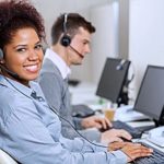 a customer service woman who is assisting clients using one of her cloud applications so that the clients can smoothly run their small business