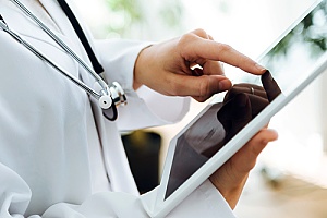 a doctor using an iPad to overcome common IT challenges