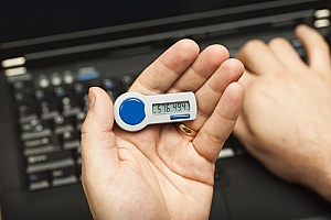 an employee holding a two-factor authentication device
