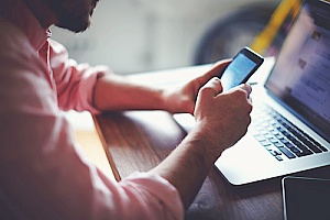 a man using his smart phone as a part of two factor authentication