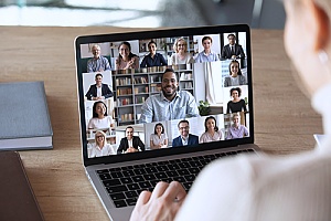 an employee on a video conference call with the rest of his team from home