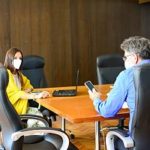 Two employees in office at desk