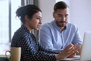 an IT support partner working with a small business owner to improve IT security