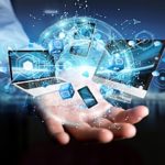 a man holding several devices representing IT trends