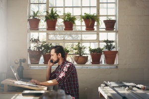 man looking up rules on Compliance Regulations For Your Small Business