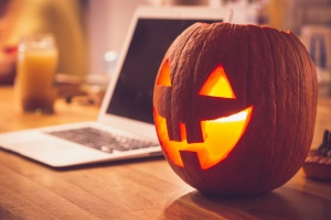 computer and pumpkin on a table