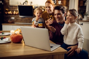 family using computer to talk to friends