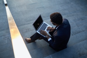 women outside on computer doing Digital Clutter on computer