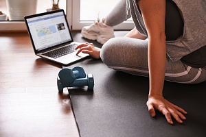 women finding fitness videos on her computer to do at home