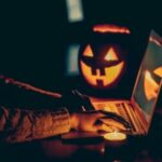 Halloween evening at the computer. Woman talking on the feast of