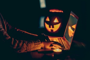 Halloween evening at the computer. Woman talking on the feast of