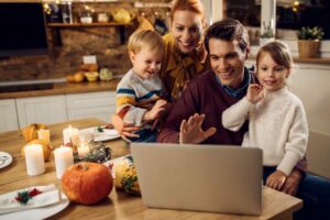 Family gathered around computer during Thanksgiving dinner