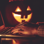 scary pumpkins on desk with computer