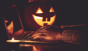 scary pumpkins on desk with computer