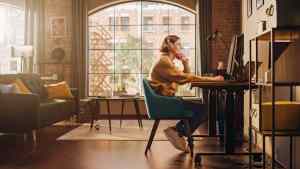 Young Handsome Man Working from Home on Desktop Computer in Sunn